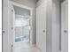 Bathroom featuring marble-look tile, a shower and a white door at 417 Manor Blvd, Palm Harbor, FL 34683