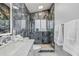 The bathroom features gray marbled tile, a glass enclosed shower and a marble counter at 417 Manor Blvd, Palm Harbor, FL 34683