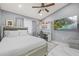 This bedroom features a comfy bed, ceiling fan, TV, and a charming workspace at 417 Manor Blvd, Palm Harbor, FL 34683