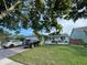 Charming house with brick driveway and lush green lawn providing great curb appeal for potential homeowners at 417 Manor Blvd, Palm Harbor, FL 34683