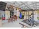 Spacious garage featuring kitchen appliances, work out equipment and overhead storage at 417 Manor Blvd, Palm Harbor, FL 34683