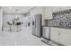 A modern kitchen features stainless steel appliances, island seating, and tile flooring at 417 Manor Blvd, Palm Harbor, FL 34683