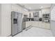 An elegant kitchen features stainless steel appliances, white cabinetry, and stylish backsplash at 417 Manor Blvd, Palm Harbor, FL 34683