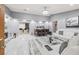 Bright open-concept living room featuring stylish marble floors, modern furnishings, and elegant lighting fixtures at 417 Manor Blvd, Palm Harbor, FL 34683