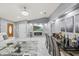 Open-concept living room features marble floors, modern fireplace, chic decor, and a dining area perfect for entertaining at 417 Manor Blvd, Palm Harbor, FL 34683
