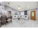 Elegant living room showcasing marble floors, a comfortable white sectional, and stylish decor with a grand crystal chandelier at 417 Manor Blvd, Palm Harbor, FL 34683