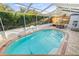 Clear blue swimming pool inside screened enclosure with outdoor seating area at 417 Manor Blvd, Palm Harbor, FL 34683