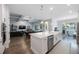 Open-concept kitchen and living area featuring a large island, ping pong table, and sleek stainless steel appliances at 425 4Th N Ave, Tierra Verde, FL 33715