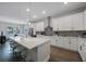 Bright, modern kitchen with stainless steel appliances, a large island, and an adjacent dining area with barstool seating at 425 4Th N Ave, Tierra Verde, FL 33715