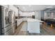 Bright kitchen with stainless steel appliances, a large island with barstool seating, and white cabinets at 425 4Th N Ave, Tierra Verde, FL 33715