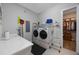 Well-equipped laundry room with modern washer and dryer, ample counter space, and storage shelves at 425 4Th N Ave, Tierra Verde, FL 33715