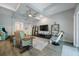 Bright living room with ceiling fan, TV, display shelves, unique lighting, comfortable seating, and wood-look floors at 425 4Th N Ave, Tierra Verde, FL 33715
