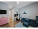 Inviting living room with stylish sofa, modern decor, and a functional workspace with dual monitors at 425 4Th N Ave, Tierra Verde, FL 33715