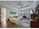 Serene main bedroom with tray ceiling, ceiling fan, neutral decor, and plenty of natural light from the windows at 425 4Th N Ave, Tierra Verde, FL 33715