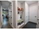 Functional mudroom with built-in bench, shoe storage, and hooks, providing a convenient entryway solution at 425 4Th N Ave, Tierra Verde, FL 33715