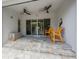 Outdoor patio area featuring tiled flooring and ceiling fans, perfect for relaxing and entertaining at 425 4Th N Ave, Tierra Verde, FL 33715