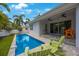 A backyard pool and patio area with seating, creating a tranquil space for relaxation and outdoor enjoyment at 425 4Th N Ave, Tierra Verde, FL 33715