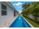 A long pool extends to the end of the house, complemented by well-kept grass and garden area at 425 4Th N Ave, Tierra Verde, FL 33715