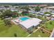 A lush aerial view of a community with a gorgeous pool, spa and large recreation building at 427 Pelican S Dr, Oldsmar, FL 34677