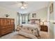 Comfortable bedroom with a floral-patterned bedspread, wood furniture, and soft natural light at 427 Pelican S Dr, Oldsmar, FL 34677