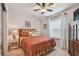 Comfortable bedroom featuring a ceiling fan, window, and dresser with a television at 427 Pelican S Dr, Oldsmar, FL 34677