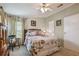 Inviting bedroom featuring a comfortable bed, wood accents, and soft natural light through the curtains at 427 Pelican S Dr, Oldsmar, FL 34677