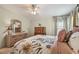 Cozy bedroom featuring a floral comforter, decorative pillows, and coordinated furniture at 427 Pelican S Dr, Oldsmar, FL 34677