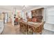 Open dining space with wooden table, seating, and hutch, flowing into a bright kitchen area at 427 Pelican S Dr, Oldsmar, FL 34677