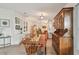 Cozy dining room with a wooden table, china cabinet, and views of the kitchen in an open floor plan at 427 Pelican S Dr, Oldsmar, FL 34677