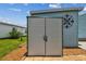 Outdoor storage unit with double doors, providing ample space for tools and equipment at 427 Pelican S Dr, Oldsmar, FL 34677