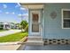 Close-up of a charming front door with decorative accents and well-maintained entry steps at 427 Pelican S Dr, Oldsmar, FL 34677