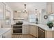 Well-lit kitchen featuring stainless steel appliances, white cabinets, and a double oven at 427 Pelican S Dr, Oldsmar, FL 34677