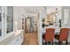 Bright kitchen with stainless steel appliances, white cabinets, and views into the dining area at 427 Pelican S Dr, Oldsmar, FL 34677