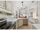 Modern kitchen featuring stainless steel appliances, ample counter space, and views of the dining area at 427 Pelican S Dr, Oldsmar, FL 34677