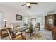 Open-concept living room featuring neutral decor, a ceiling fan, and an elegant furniture set at 427 Pelican S Dr, Oldsmar, FL 34677
