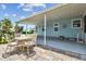 Inviting outdoor patio featuring a dining set with views of the surrounding landscape at 427 Pelican S Dr, Oldsmar, FL 34677