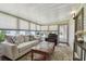 Inviting sunroom with cozy seating, a coffee table, and lots of natural light through the windows at 427 Pelican S Dr, Oldsmar, FL 34677