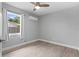 This bedroom features wood floors, a ceiling fan and a bright window at 4300 Maple Ne St, St Petersburg, FL 33703