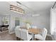 Light-filled dining room with modern chandelier and seating for six at 4300 Maple Ne St, St Petersburg, FL 33703