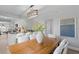 Open dining room with a wooden table, chandelier, and views of the kitchen at 4300 Maple Ne St, St Petersburg, FL 33703