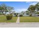 Charming single-story home with well-maintained lawn and mature trees, offering curb appeal at 4300 Maple Ne St, St Petersburg, FL 33703