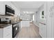 Updated kitchen featuring white cabinets, stainless steel appliances, and a dining area at 4300 Maple Ne St, St Petersburg, FL 33703