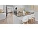 Open kitchen with counter seating, granite countertops, and stainless steel appliances at 4300 Maple Ne St, St Petersburg, FL 33703