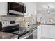 Contemporary kitchen with stainless steel appliances, granite countertops, and modern backsplash at 4300 Maple Ne St, St Petersburg, FL 33703