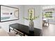 Stylish living room console with greenery and a view into the dining room at 4300 Maple Ne St, St Petersburg, FL 33703