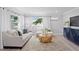 Inviting living room featuring contemporary furnishings, wood-look floors, and bright natural light at 4300 Maple Ne St, St Petersburg, FL 33703