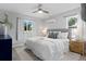 Main bedroom showcasing plush bedding, wood floors, and window views at 4300 Maple Ne St, St Petersburg, FL 33703