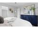 An interior view of main bedroom, with stylish blue cabinet and decorative plants at 4300 Maple Ne St, St Petersburg, FL 33703