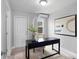 Bright office space with black desk, abstract artwork, and natural light at 4300 Maple Ne St, St Petersburg, FL 33703