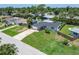 Aerial view of a home with a well-manicured lawn and an in-ground swimming pool at 4518 Helena Ne St, St Petersburg, FL 33703